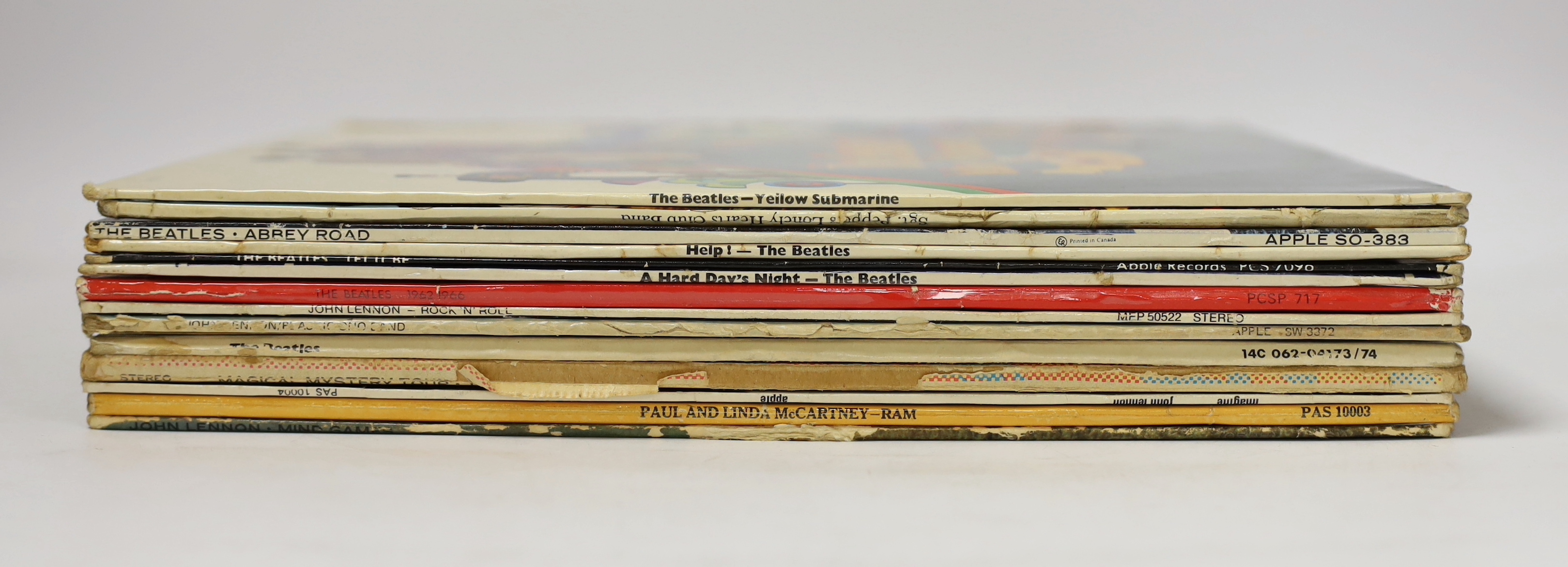 Fourteen Beatles and related LP albums, including a late pressing of the White Album (complete with the four photos), Magical Mystery Tour, Yellow Submarine, Sergeant Pepper, Abbey Road, Help, Let It Be, Hard Days Night,